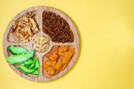 Mixture of dried fruits on color background. Symbols of the Jewish holiday Tu Bishvat. Flat lay, top view. with copy spaceの写真素材