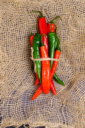 red green hot chili pepper on a dark vintage culinary background, top view