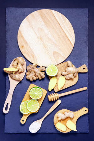 concept of healthy eating. fruits root of ginger, slices lime, honey, with copy space. vertical photoの写真素材