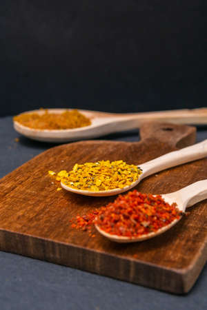 spices in a wooden bowl close-up on a brown wooden background. selective focusの写真素材