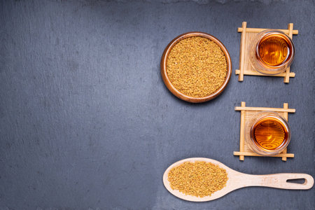 Tea of fenugreek, seeds on a wooden surface. relief from anemia, loss of taste, fever, alternative medicineの写真素材