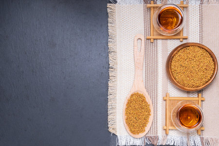 Fenugreek Seeds or MethiDana drink by speaking it in water overnight. close up. flat lay