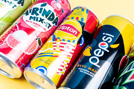 Tyumen, Russia-December 10, 2020: Mirinda, Pepsi, mountain dew, Lipton. aluminum soda cans on a yellow backgroundのeditorial素材