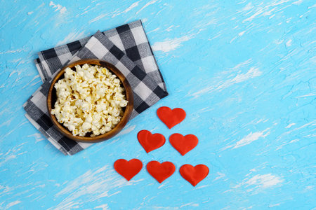 Popcorn. Flat lay a Cup of popcorn on a blue background. The view from the topの写真素材