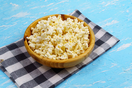 Popcorn. Flat lay a Cup of popcorn on a blue background. The view from the topの写真素材