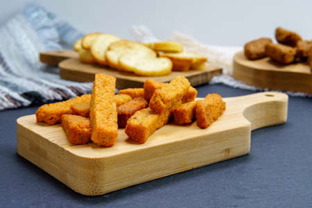 brown toast crackers croutons on a wooden board space for copying text, no wasteの写真素材
