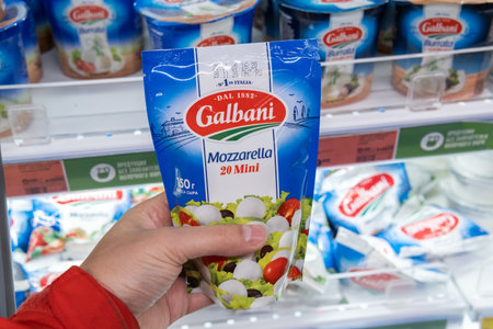 Tyumen, Russia-November 07, 2020: Man hand holding pack with delicious Galbani Mozzarella at the...