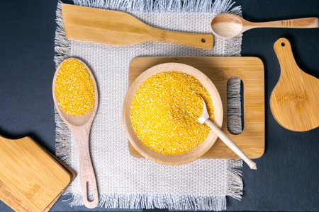 Organic raw Corn corn grits on black background. Eco Food Concept. GMO-free conceptの写真素材