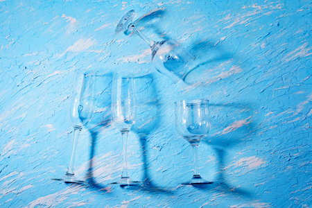 Empty wine glasses, the container for the alcoholic beverage. blue background.の写真素材