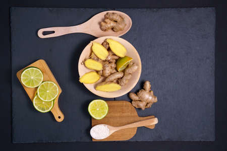 lime raw ginger honey root. Dry ginger dark background. Copy space. Flat layの写真素材