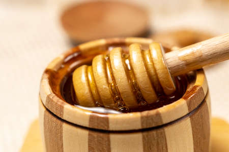 Honey in a wooden bowl. Close-up macro. Healthy organic honey. selective focusの写真素材