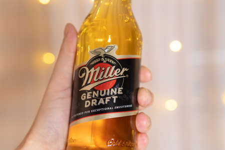 Tyumen, Russia-February 13, 2021: Miller Genuine Draft Beer in the original bottle alcoholic beverages. Selective focusのeditorial素材