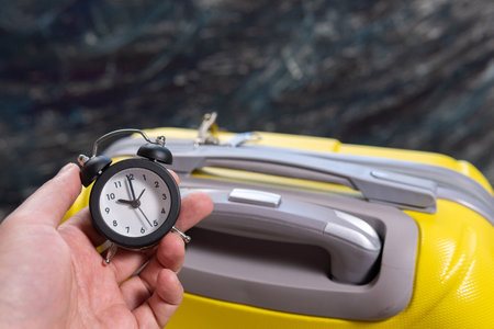 alarm clock time for travel, home away from home. Preparation for vacation or travel.の写真素材