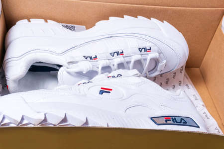 Tyumen, Russia-November 27, 2020: women white sneakers FILA in a box. Fila is one of the world s...