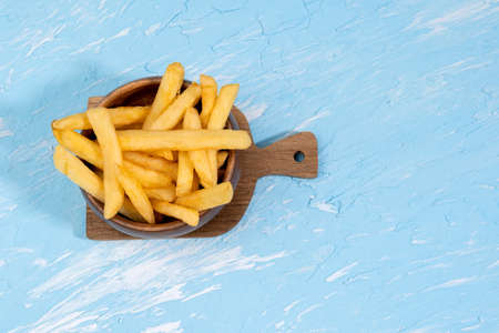 french fries on a blue background top view. space for copying text. Fast food, junk food, diet...