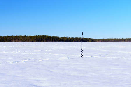equipment for winter fishing on the ice. drill for winter fishing. space for copying textの写真素材