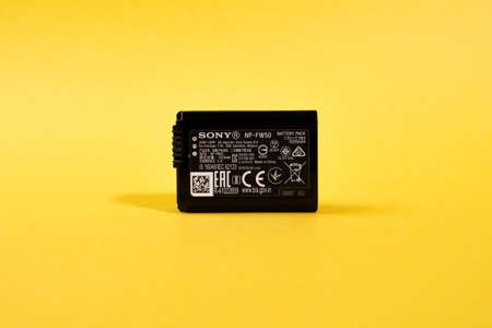 Tyumen, Russia-March 15, 2021: Sony NP-FW50 battery, photo on yellow background.のeditorial素材