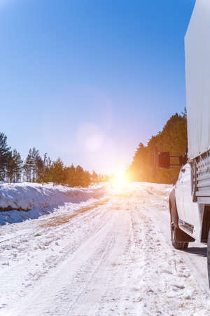 car on a winter road. Adventure. car on winter snowy road in mountains in sunny day. Vertical photoの写真素材
