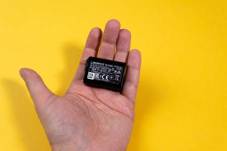 Tyumen, Russia-March 15, 2021: Sony NP-FW50 battery, photo on yellow background.