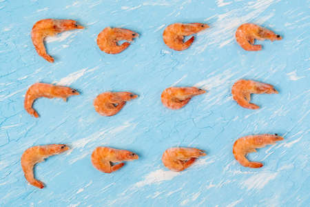 Fresh prawns on a blue table, top view. Culinary eating of seafood.の写真素材