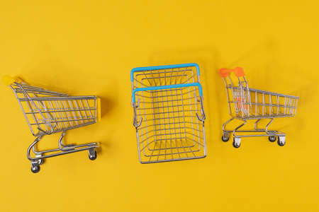 Empty basket on a yellow background. The concept of shopping and discounts on Black Friday.の写真素材