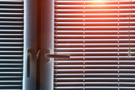 Aluminum blinds on the office windows. Made from metal. Modern sun protection and window decoration.の写真素材