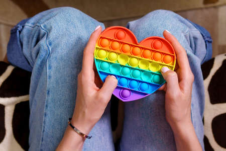 Colorful antistress sensory toy push pop in girl hands.の写真素材