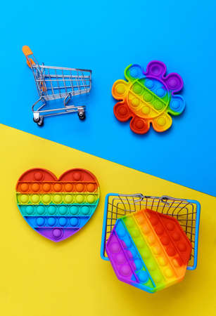 Rainbow anti stress toy fidget push silicone toy antistress pop it. Multi colored backgroundの写真素材
