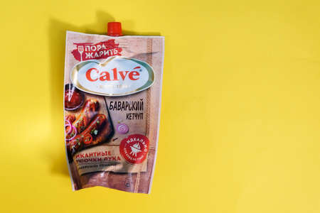 Tyumen, Russia-april 17, 2021: Calve Bavarian ketchup on a yellow background. russian packagingのeditorial素材