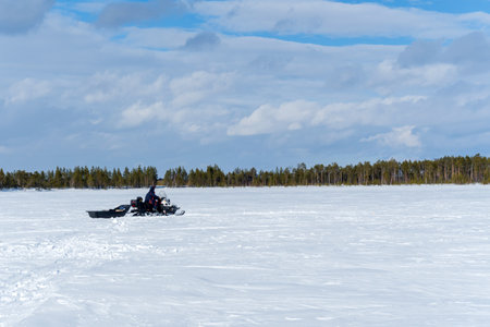 snowmobile fisherman is riding along the winter lake. landscape winter photo