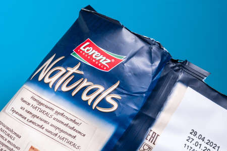 Tyumen, Russia-June 21, 2021: Lorenz Naturals parmesan cheese potato chips bag close up.
