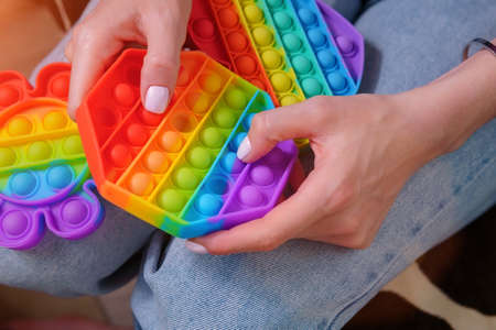 Girl plays with colorful rainbow toy. Selective focusの写真素材