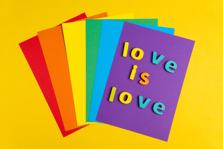 Top view of love is love lettering made on paper rainbow background.の写真素材