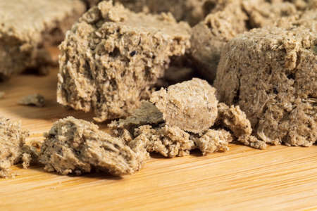 Piece of halva from sunflower seeds. Food, oriental sweetness. Pastry. Selective focus.