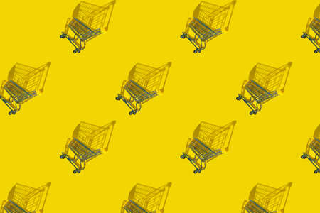 Shopping carts background with shadows, sale, yellow background. Purchase. Flat layの写真素材