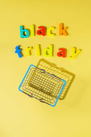 Inscription black Friday yellow background low prices, discounts, shopping on Black Friday. Flat layの写真素材