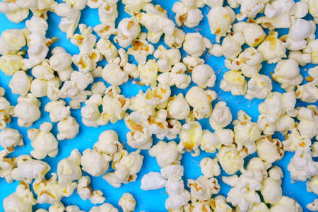National Popcorn Day January 19. White popcorn and corn cobs. Blue backgroundの写真素材