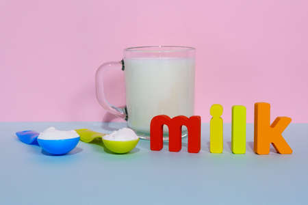 Powdered vegan milk on a multicolored background, non-dairy products selective focusの写真素材