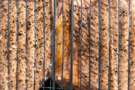 Grilled salmon fish steak barbecue meal cooking, prepared on bbq grill, close upの写真素材