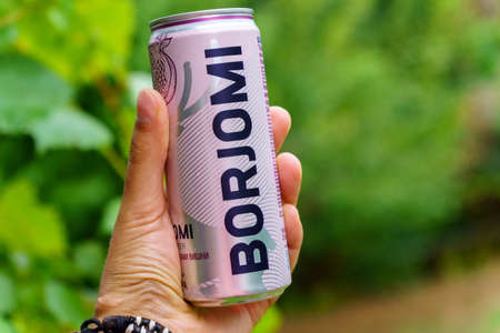 Volzhsky, Russia-September 25, 2021: Borjomi in a tin can with cherry and pomegranate without sugar...