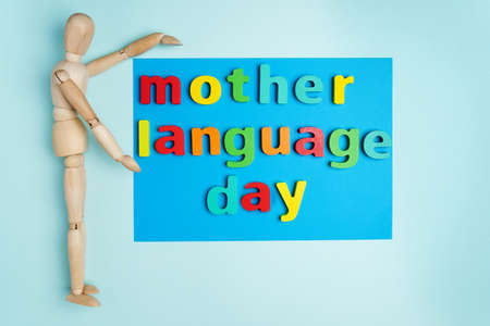 Word international mother language day text on a blue background. Top view. Copy Spaceの写真素材