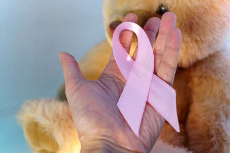 Cancer awareness pink ribbon. Childrens Cancer Day, February 15.