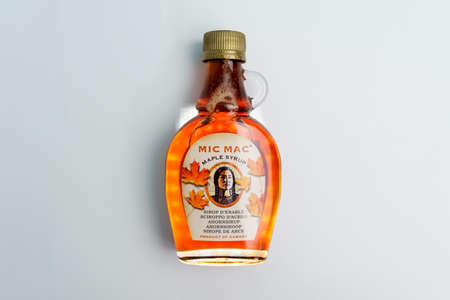 Tyumen, Russia-December 08, 2021: Mic Mac Maple syrup bottle of Canadian Maple Syrup. Multicolored...