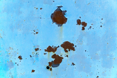 Color background: rusty metal surface with blue paint, peeling texture.の写真素材