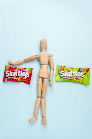 Tyumen, Russia-December 27, 2021: Skittles is a fruit flavoured sweets. Wrigley Jr. Company. Vertical photoのeditorial素材