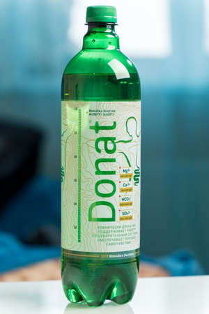 Tyumen, Russia-December 20, 2021: Water donat mineral logo close-up. Selective focus. Vertical photo