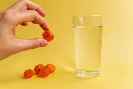 Dissolvable drinks dissolving cubes to add superfoods. On a yellowbackgroundの写真素材