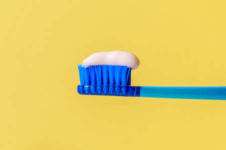 Toothbrush paste on toothbrush close up. Applying toothpaste to the brush close-up. Copy spaceの写真素材
