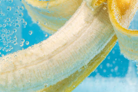 Banana fruit close-up in water, under water. Ripe juicy fruit macro. Delicious ripe bananas.の写真素材