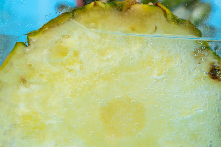 Pineapple close-up macro in the water under the water. Selective focus
